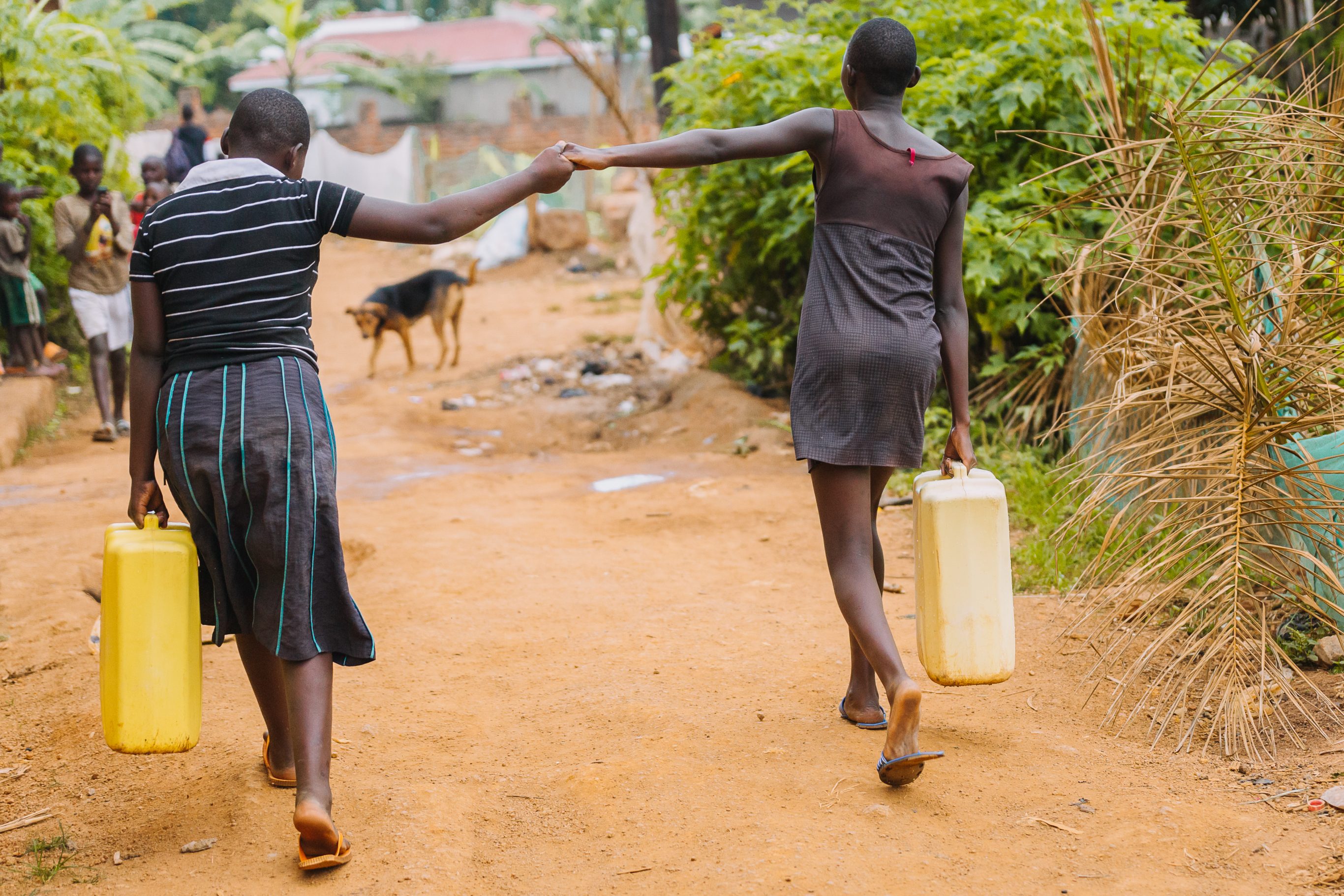 Uganda girls carrying water